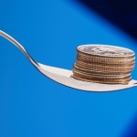A spoon with cash, representing a cash reward for weight loss. (iStock Photo)