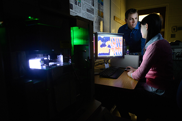 Graduate student Linghan Ye and Bryan Huey review microscope data at IMS on Jan. 16, 2015. (Peter Morenus/UConn Photo)