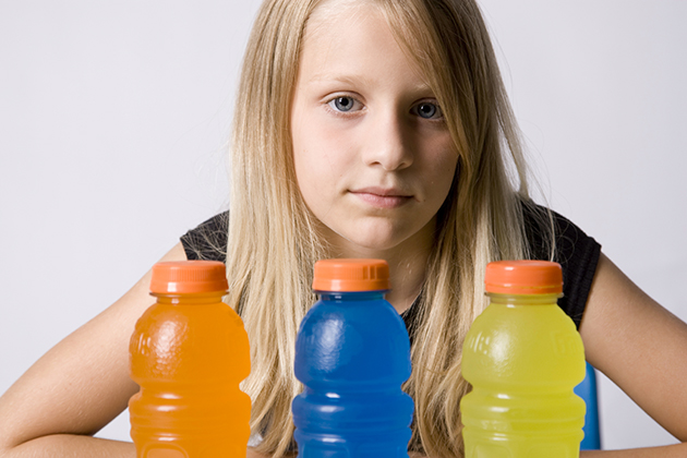 A child with bottles of sugary drinks. (iStock Photo)
