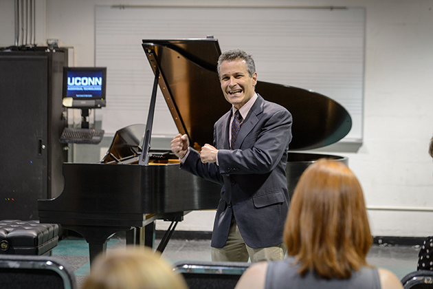 Eric Rice, chair of the music department talks before a performance on a new Steinway & Sons grand piano just delivered to the Music Building on May 7, 2015. (Peter Morenus/UConn Photo)