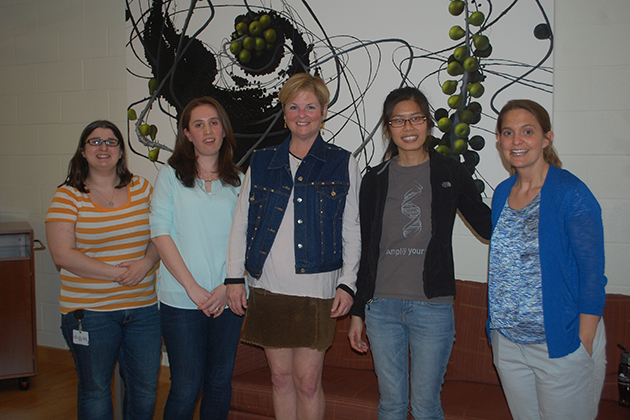 UConn Health geneticist Stormy Chamberlain, right, with from left, Carissa Sirois (Ph.D. student), Noelle Germain (post-doc), Roberta Burns (visitor with the Angelman group), and Pin-Fang Chen (Ph.D. student). (Barbara Glassman Dell for UConn)