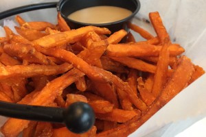 Getting a sweet start to lunch with sweet potato fries and maple sauce at Chuck and Augie's Restaurant. (Abby Mace/UConn Photo)