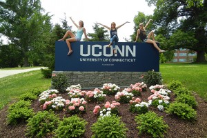 Me and my friends and teammates on the UConn Track & Field Team Laura and Kat, perch on top of the UConn sign at the corner of North Eagleville and Storrs Roads. (Abby Mace/UConn Photo)