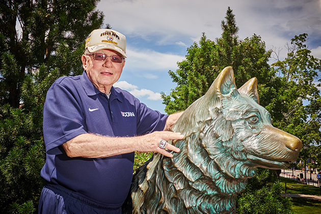 Harry Hartley, president emeritus, with the Jonathan statue on July 16, 2015. (Peter Morenus/UConn Photo)