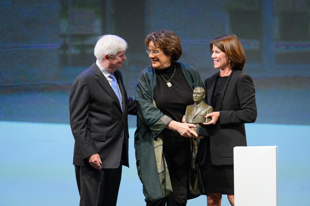 Molly Melching, center, founder and chief executive officer of Tostan, receives an award from former Senator Christopher Dodd, left, and Helena Folks, chair of the national advisory board during the ceremony to award the Thomas J. Dodd Prize in International Justice and Human Rights held at the Jorgensen Center for the Performing Arts on Oct. 15, 2015. (Peter Morenus/UConn Photo)