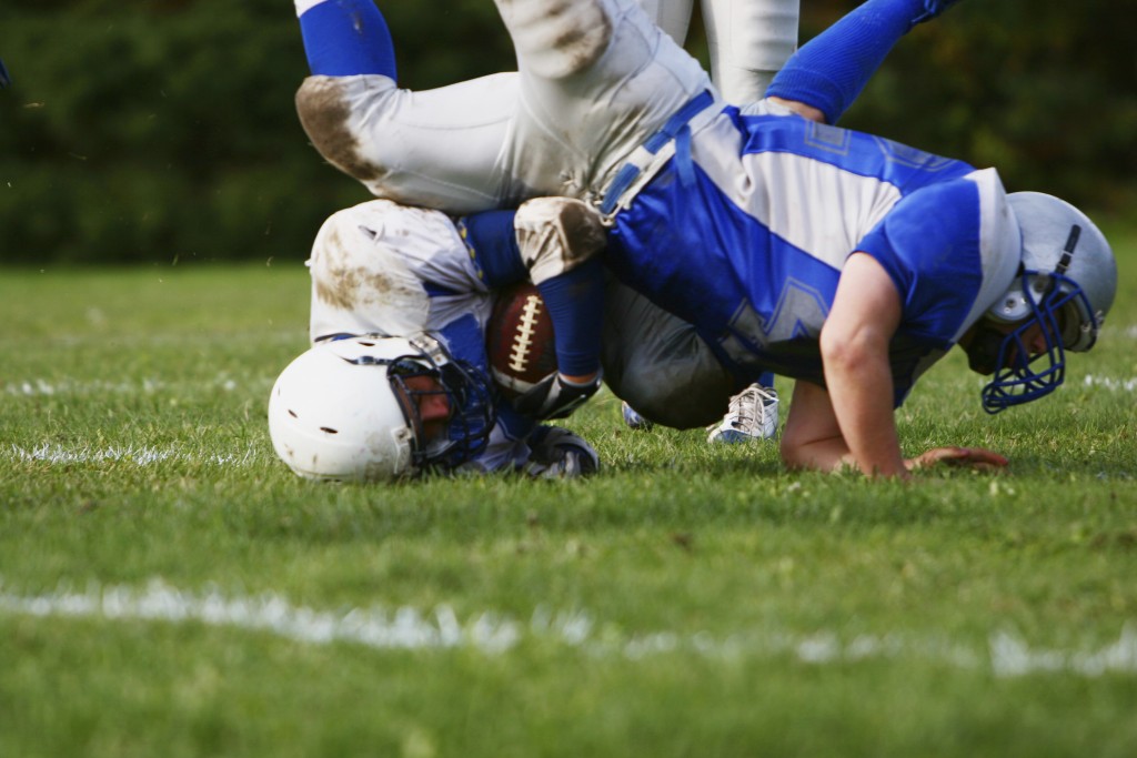 A football player falls head-first during a game. (iStock Photo)