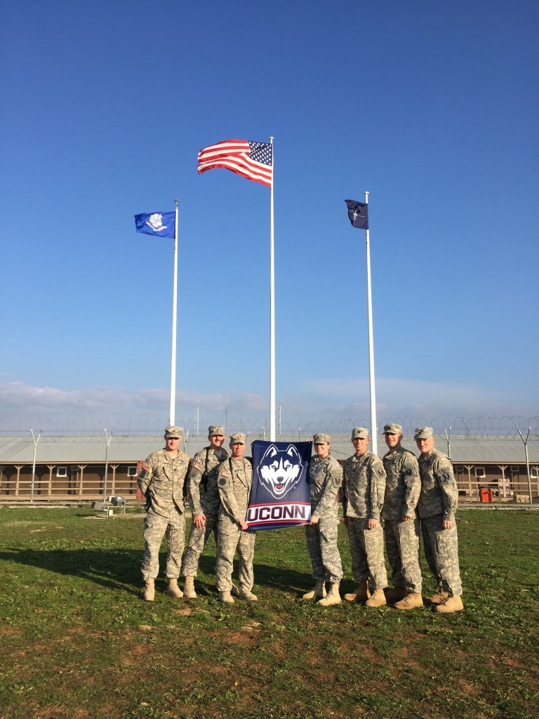 These members of Husky Nation show their pride in UConn while serving in Kosovo. (Photo courtesy of Krista Yaglowski)
