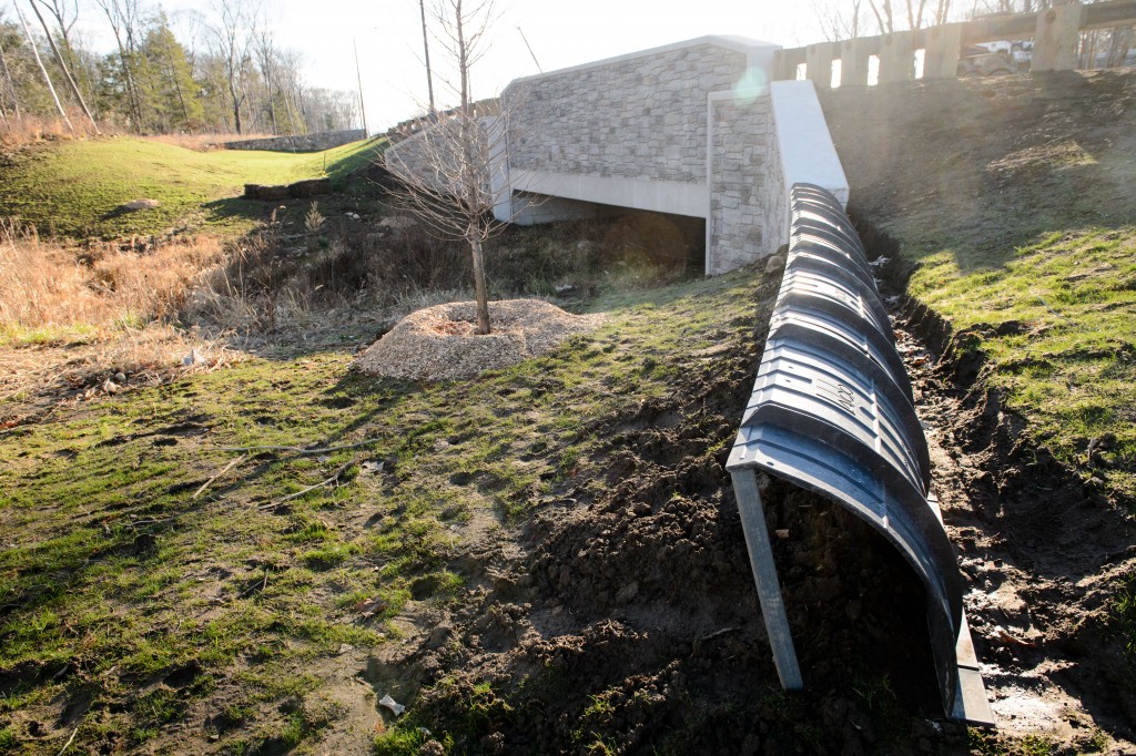 These curved amphibian barriers are being installed to direct wildlife under bridges along the completed Hillside Road extension. (Peter Morenus/UConn Photo)