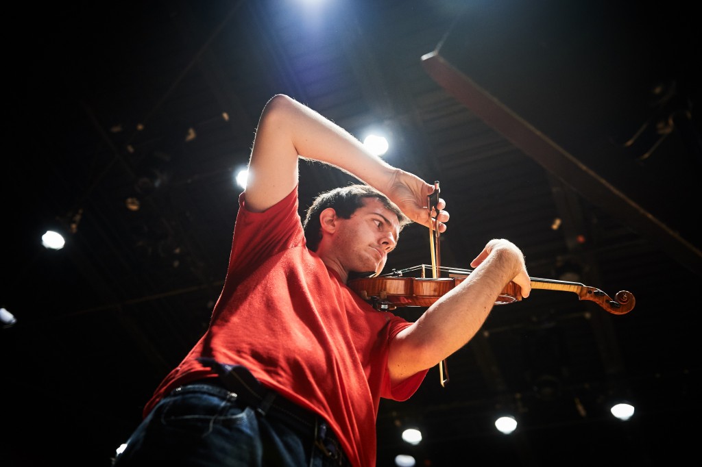 Myles Mocarski '16 (SFA) plays solo violin during a rehearsal with the University Symphony Orchestra. One of the winners of the concerto competition, he will perform at von der Mehden Recital Hall on Dec. 10. (Peter Morenus/UConn Photo)