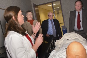 Medical student Mary Cearley shows state lawmakers how she trains on a high-tech simulation patient. Legislators include Sen. Beth Bye, Sen. Joe Crisco, and Rep. Kevin Ryan. (Janine Gelineau/UConn Health).