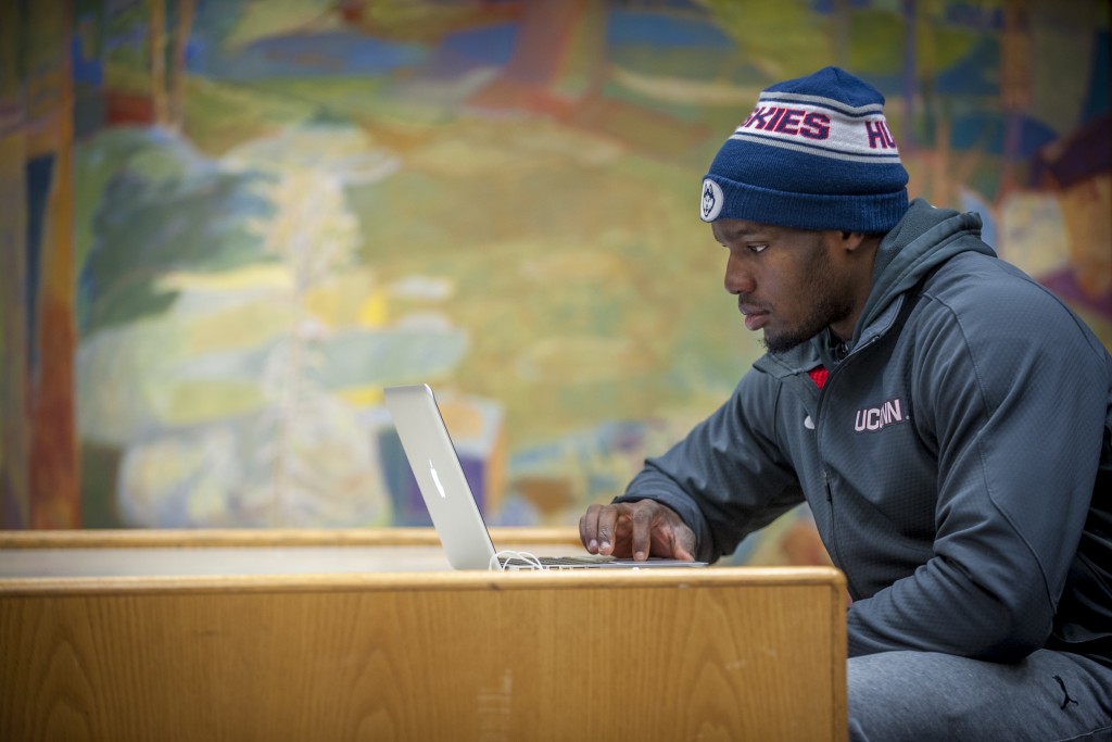 Student-athlete Nnamdi Amilo, men’s basketball studying at Homer Babbidge Library. (Sean Flynn/UConn Photo)