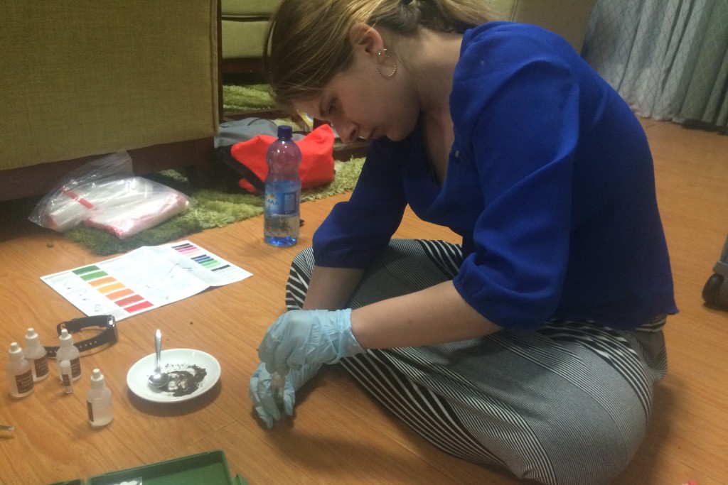 Kelsey Reeves '16 (ENG) tests soil samples for nutrients in her hotel room.