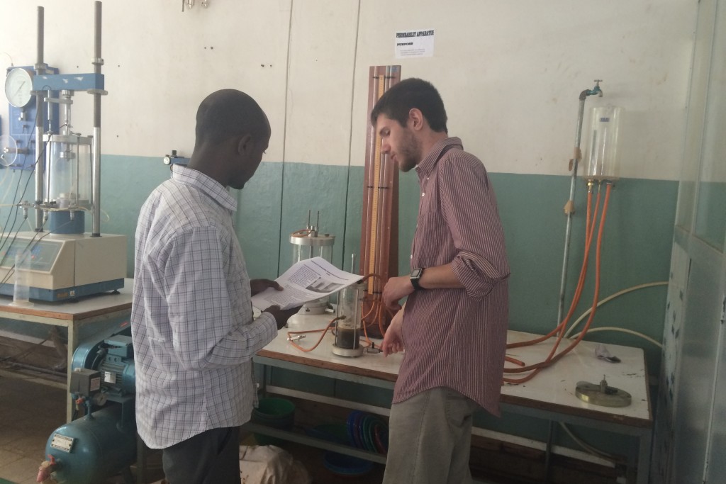 Mamo Kassegn Sisay, left, a researcher with the Ethiopian Institute of Water Resources, and Ryan Cordier '18 (ENG) measure the permeability of the soil. The cylinders behind them measure how fast water travels through soil.