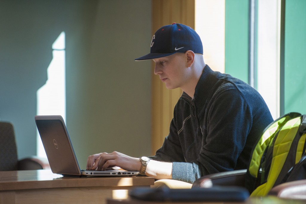 Student-athlete Ryan Radue '15 (BUS), '17 MS (baseball) studying. (Sean Flynn/UConn Photo)