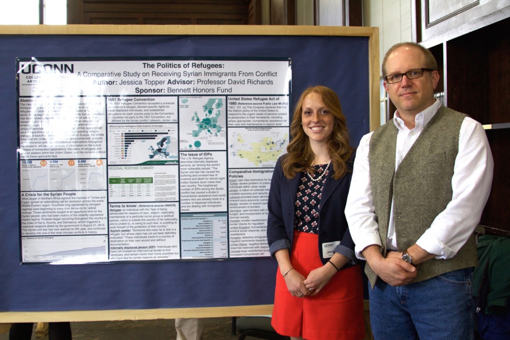 Jessica Topper '16 (CLAS), with her advisor, associate professor of political science David Richards, presented 'The Politics of Refugees' poster on April 8, 2016. (UConn Photo/Sydney Lauro ’17 (CLAS))