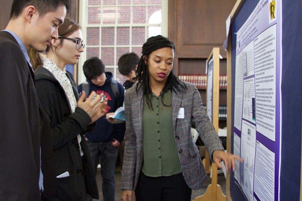 Shanicka Reynolds ’16 (CLAS) discusses her research on a potential antidepressant with fellow students. (UConn Photo/Sydney Lauro ’17 (CLAS))