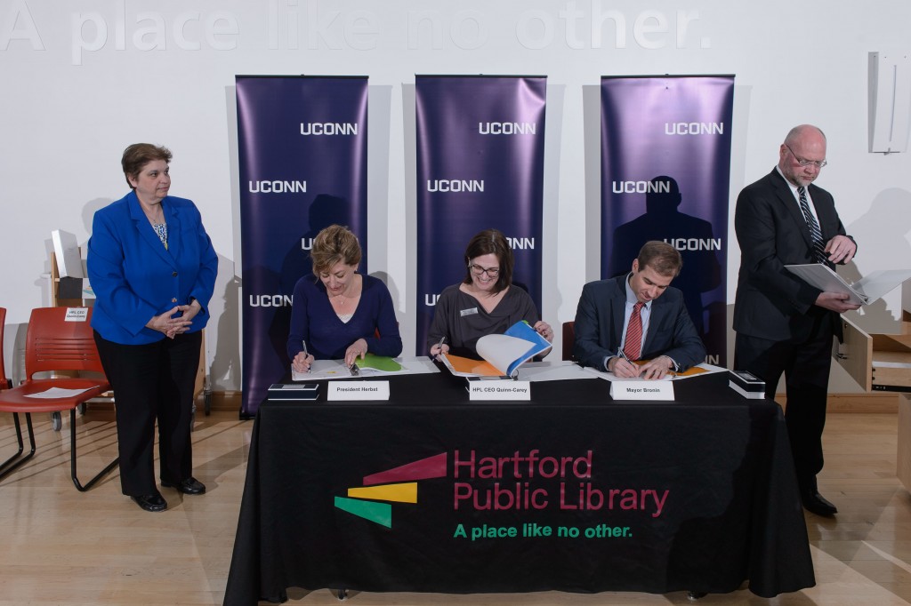 A ceremony held on April 21, 2016 at the Hartford Public Library to sign an agreement to host the new downtown UConn Hartford library there. From left are HPL CAO Mary Tzambazakis, President Susan Herbst, HPL CEO Bridget Quinn-Carey, Mayor Luke Bronin and UConn attorney Robert Sitkowski. (Peter Morenus/UConn Photo)