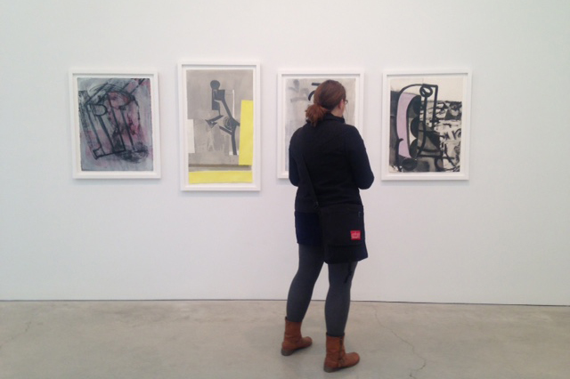 MFA candidate Erin Smith views works on display at the Volta Show on Pier 90 during Armory Arts Week in New York City. (Photo courtesy of students in ART 5310 Graduate Seminar)