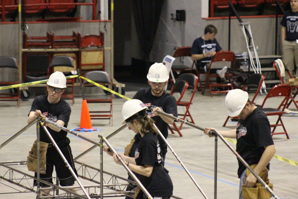     The UConn Steel bridge team assembling their bridge at the New England competition. Left to right are Kevin McMullen, Manal Tahhan, Dennis Gehring, and Richard Breitenbach. (photo courtesy of Francis McMullen)