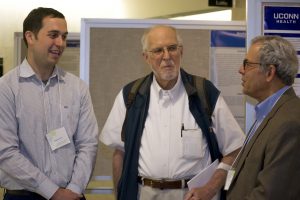 From left, fifth-year PhD student Spenser Smith talking with former SCOB director William Upholt and Jon Goldberg, the programs co-director. (Photo by Tina Encarnacion)