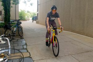 Josh Mills, who normally bikes straight to Munson Road from New Hartford daily, takes a detour to the July bike to work breakfast table. (Photo by Tina Encarnacion)