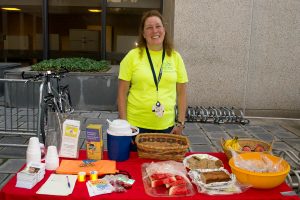 Joyce Fritz offers breakfast snacks to bike commuters, including homemade oatmeal raisin cookies, homemade granola, homemade banana bread, fresh fruit and drinks. (Photo by Tina Encarnacion)