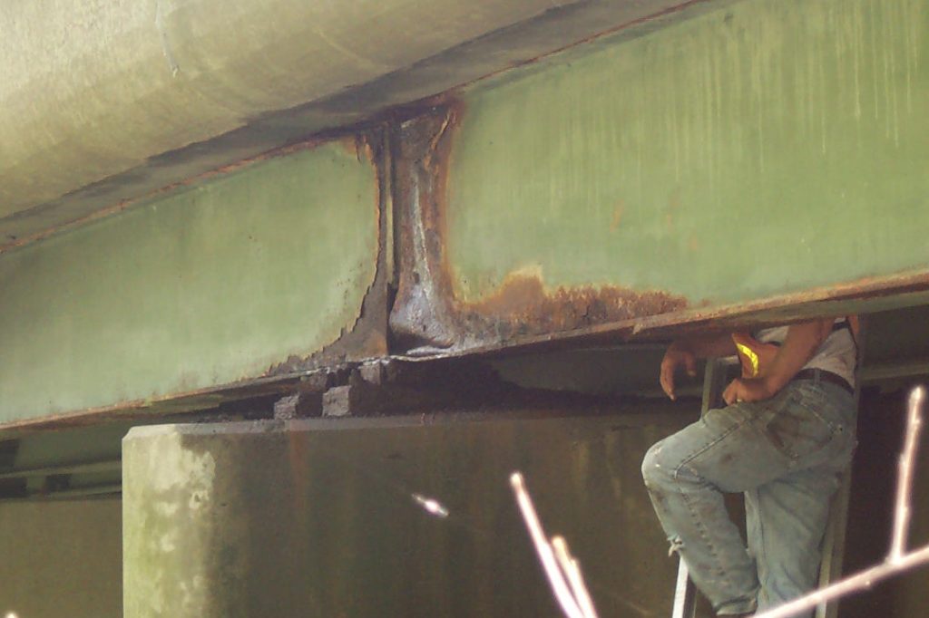 A bridge, showing corrosion of a steel beam. (Photo courtesy of CME Engineering)