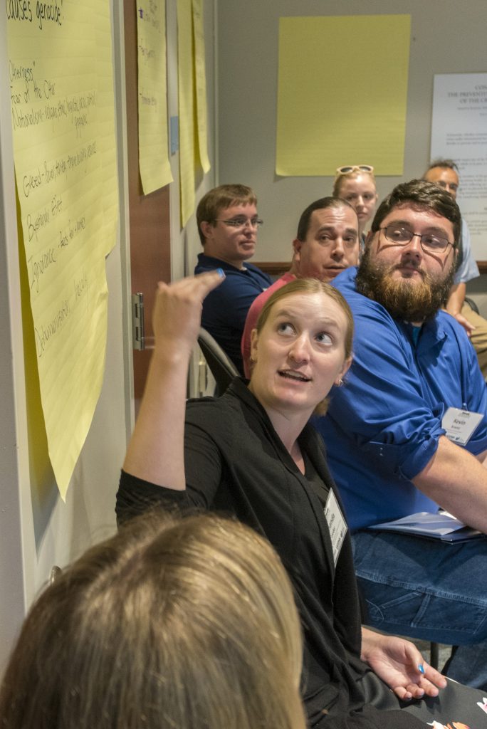 A participant in the 2016 Intellectual Humility in Secondary Education Summer Institute discusses the question, What do you think causes genocide? at the Thomas J. Dodd Research Center on Aug. 1, 2016. (Sean Flynn/UConn Photo)