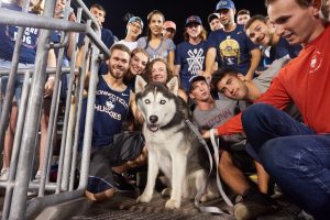 Students pose for a photo with Jonathan XIV during a football game at Pratt & Whitney Stadium at Rentschler Field on Sept. 1, 2016. (Peter Morenus/UConn Photo)