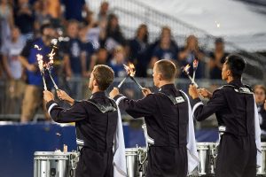 The UConn Marching Band drummers perform with flaming drumsticks during a football game at Pratt & Whitney Stadium at Rentschler Field on Sept. 1, 2016. (Peter Morenus/UConn Photo)