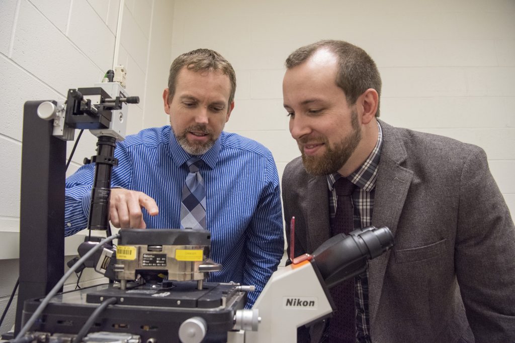 UConn engineering professor Bryan Huey, left, and post-doc Justin Luria prepare a specimen for study under a customized Atomic Force Microscope (AFM) in UConn’s Institute of Materials Science. Huey and Luria were part of a team that developed a breakthrough materials mapping technique that can be used to produce unique 3-D images of materials at the nanoscale. (Ryan Glista/UConn Photo)
