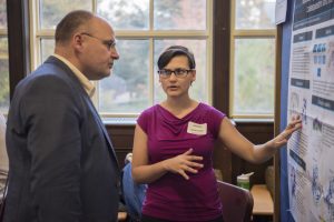Gabriella Regianno ’17 (CLAS) discusses her research at the Fall Frontiers in Research Poster Exhibition in Wilbur Cross South Reading Room on Oct. 26, 2016. (Ryan Glista '16 (CLAS)/UConn Photo)