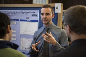 Cameron Flower ’17 (ENG) discusses his research at the Fall Frontiers in Research Poster Exhibition in Wilbur Cross South Reading Room on Oct. 26, 2016. (Ryan Glista '16 (CLAS)/UConn Photo)