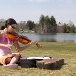 Michelle Slajda, a freshman, practices her viola by Mirror Lake.