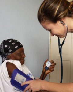 Dr. Jessica Lozier, UConn Health internal medicine resident, take a patient's blood pressure. (Photo by Susan Levine)