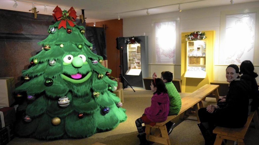 Children interact with Tinsel the Talking Christmas Tree in Old Sturbridge Village.