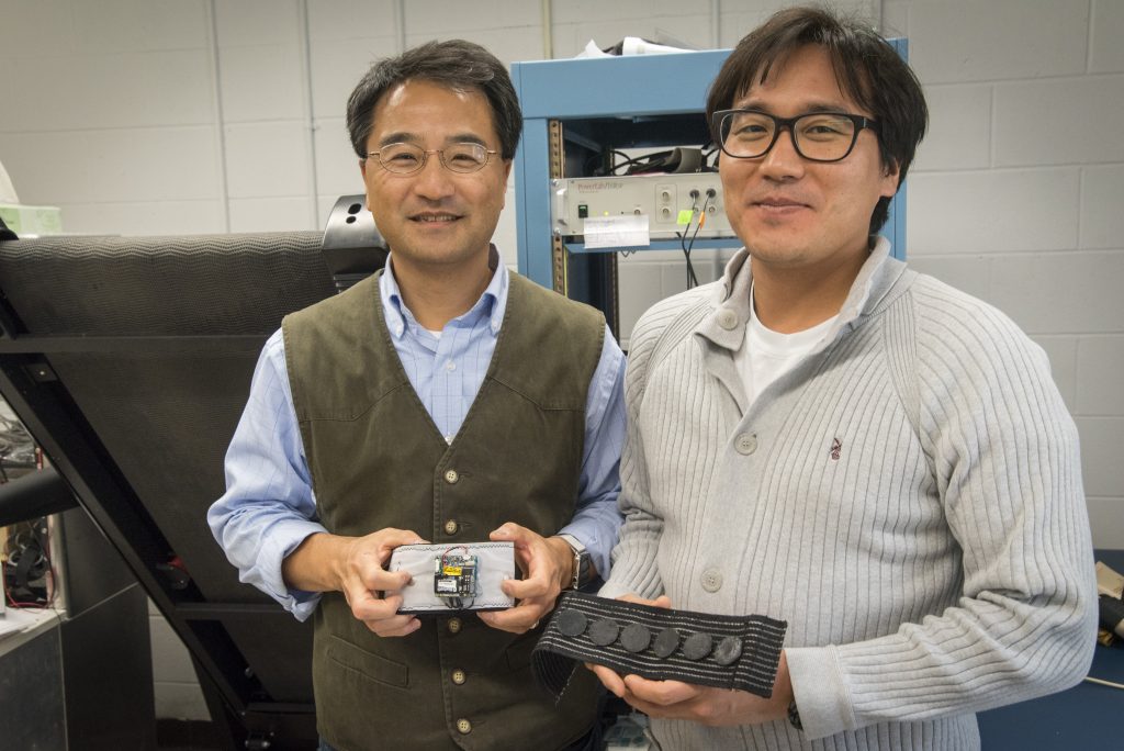 At left Ki Chon, department chair of biomedical engineering, and graduate assistant Yeon Noh, have developed a device that can monitor for an irregular heartbeat for months. (Sean Flynn/UConn Photo)