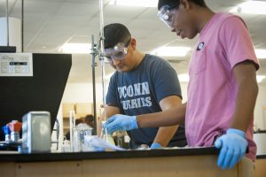 Conducting an experiment during chemistry class at Stamford on Oct. 19, 2016. (Sean Flynn/UConn Photo)