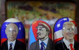 Traditional Russian wooden matryoshka doll with a picture of President-elect Donald Trump (right), Vladimir Lenin, a Soviet politician and statesman (center) and Russian President Vladimir Putin (left) at the fair on the Red Square in Moscow. (Photo by Danil Shamkin/NurPhoto via Getty Images)