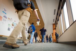 Busy hallway of Laurel Hall between classes on Jan. 17, 2017. (Sean Flynn/UConn Photo)