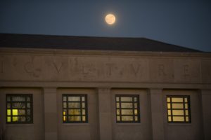 The moon over the Young Building on Dec. 12, 2016. (Sean Flynn/UConn Photo)