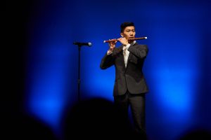 Kenneth Wong plays the flute during the Hong Kong Student Association's performance at Asian Nite. (Peter Morenus/UConn Photo)