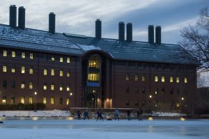Students play ice hockey at Swan Lake, against the backdrop of the Chemistry Building, on Feb. 2, 2017. (Ryan Glista/UConn Photo)
