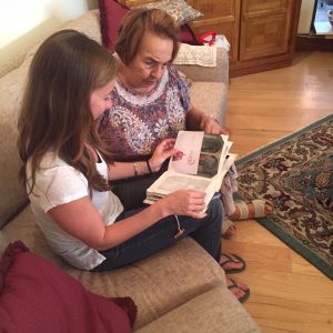 Carrie Margeson and her grandmother look back through one of the family's scrapbooks.