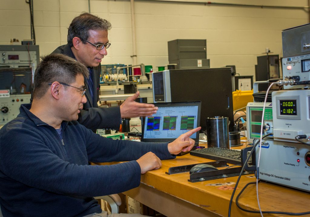 Rampi Ramprasad, professor of materials science and engineering, and Yang Cao, associate professor of electrical engineering, discuss their research. (Christopher LaRosa/UConn Photo)