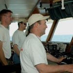 Dan Nelson, Captain of the RV Connecticut, with crew members Dan Nelson and David Cohen, navigate from the control room. (UConn File Photo)