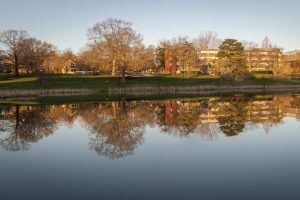Reflection of South Campus on Mirror Lake on April 18, 2017. (Sean Flynn/UConn Photo)