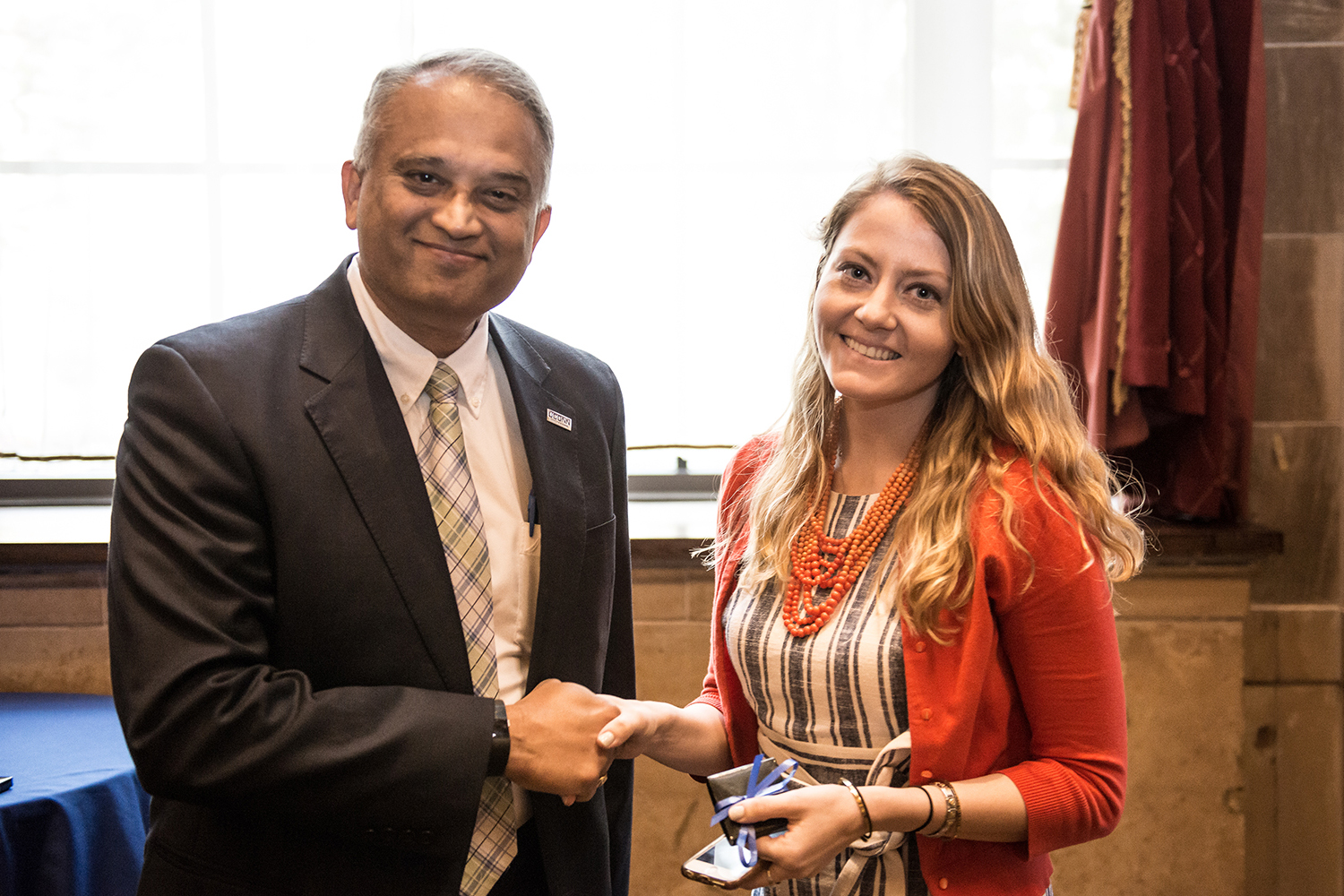 Associate Dean Suresh Nair shakes hands with Jenny Kowalski ’17 MBA at the annual MBA Awards Ceremony earlier this month. (Nathan Oldham/UConn photo)