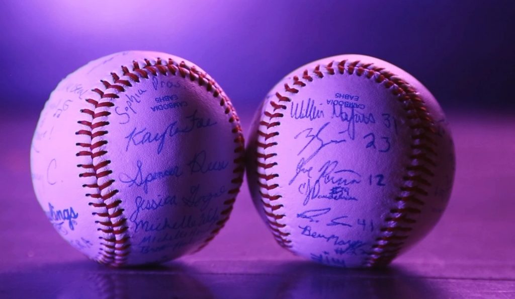 Two baseballs, one signed by the music students, the other by the baseball team. (Kenneth Best/UConn Photo)