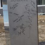 Attendees signed the capsule before it was lowered into the concrete vault. (Christopher LaRosa/UConn Photo)